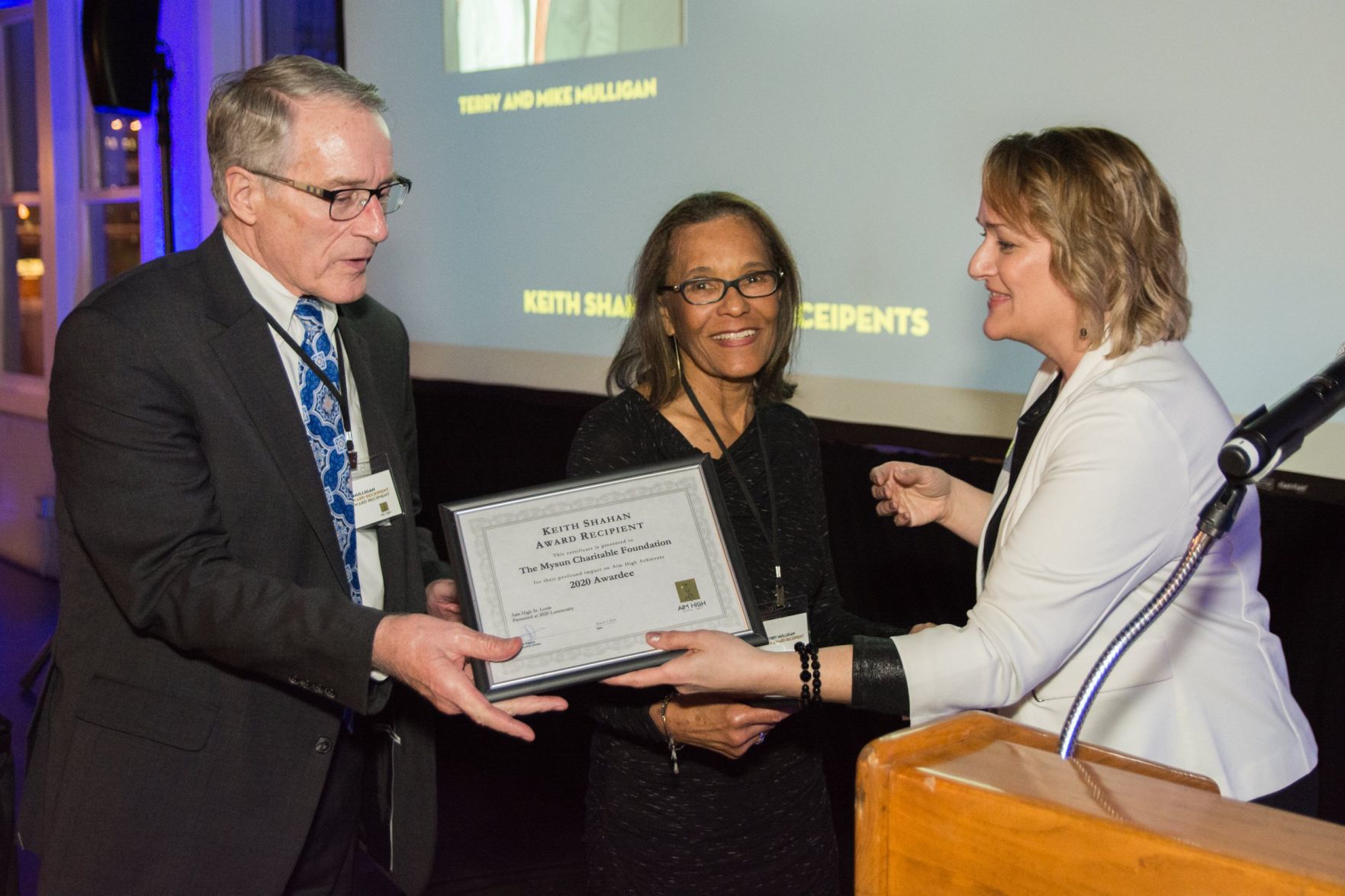 Julie Angelica presents the Keith Shahan award to Mike and Terry Mulligan
